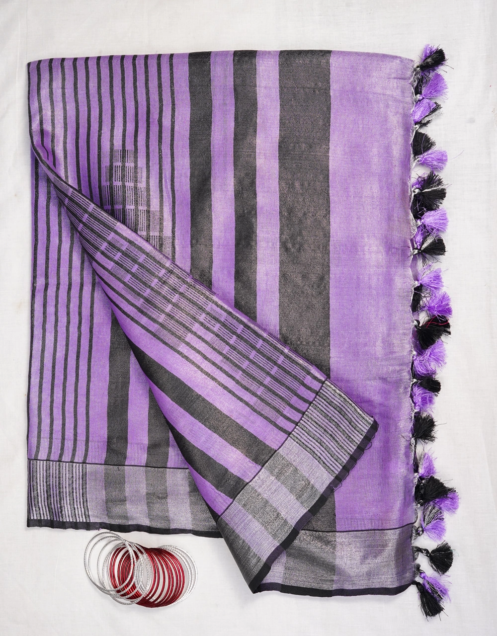 Hovered view of Lavender Purple And Charcoal Striped Tissue Linen Saree With Contrast Tassels