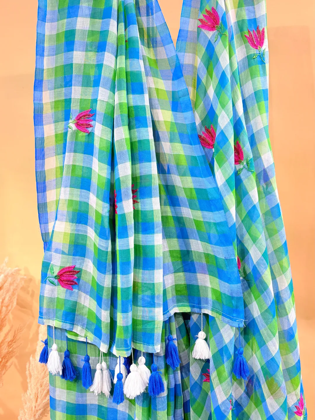 Hovered view of Blue And Green Checked Bengal Mul Cotton Saree With Pink Floral Embroidery And Tassels