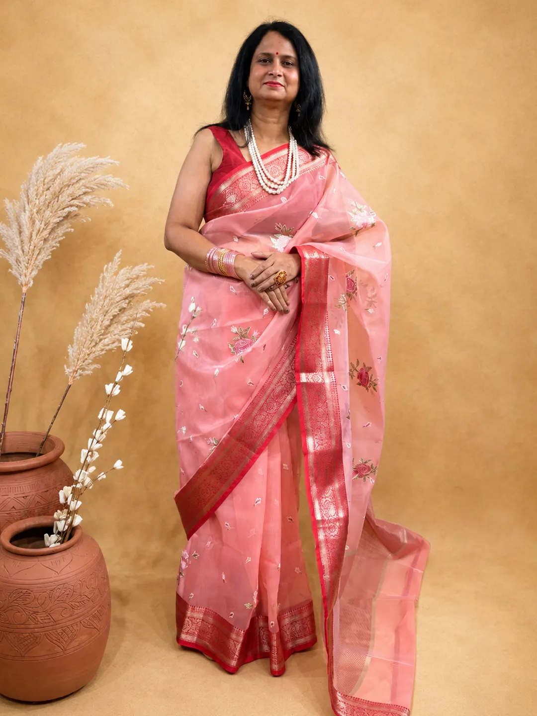 Pink Organza Blend Saree In Peach Pink With Floral Embroidery And Zari Border front view