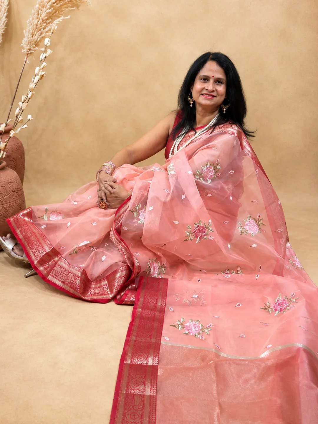 Pink Organza Blend Saree In Peach Pink With Floral Embroidery And Zari Border front view